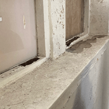 Rotten window frames and broken windows.